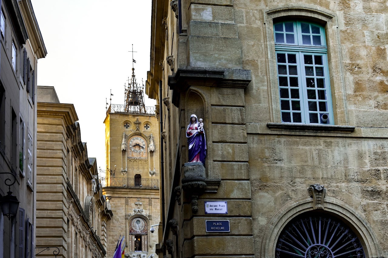 Place Richelme ad Aix-en-Provence con una edicola votiva e la Torre dell'Orologio sullo sfondo